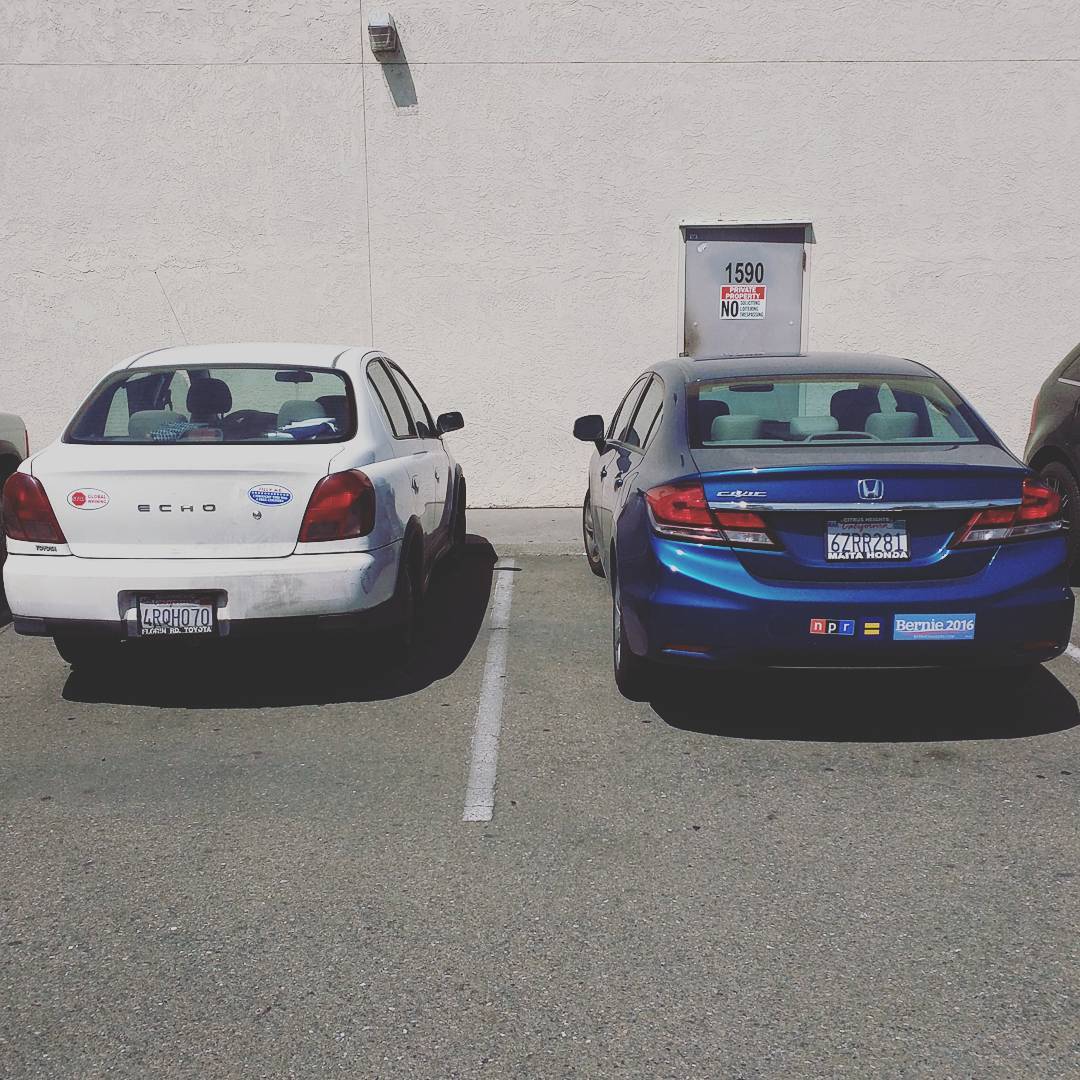 Ill let you guess which car has the climate-change-denial sticker. #feelthebern
